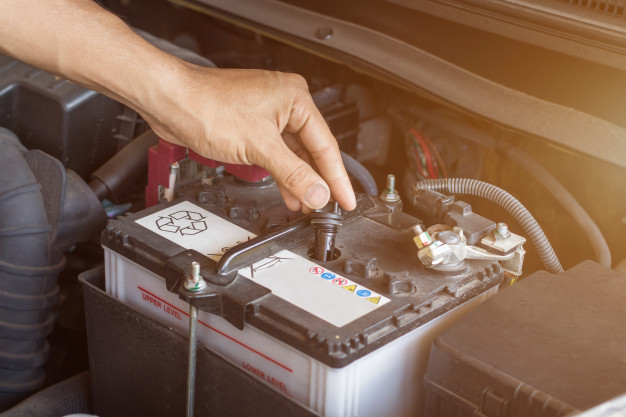 auto-mechanic-working-check-system-water-battery-fill-old-car-engine-service-station-change-repair-before-drive_38161-1227